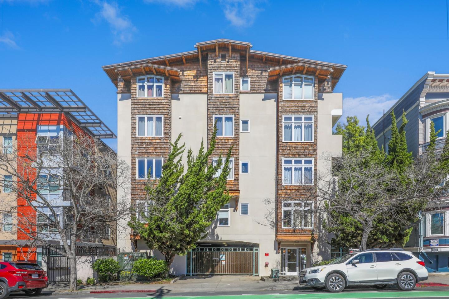 2029 Channing Way, Unit 3C Berkeley, CA 94704 - Photo 1 of 31 a front view of a residential apartment building with a yard