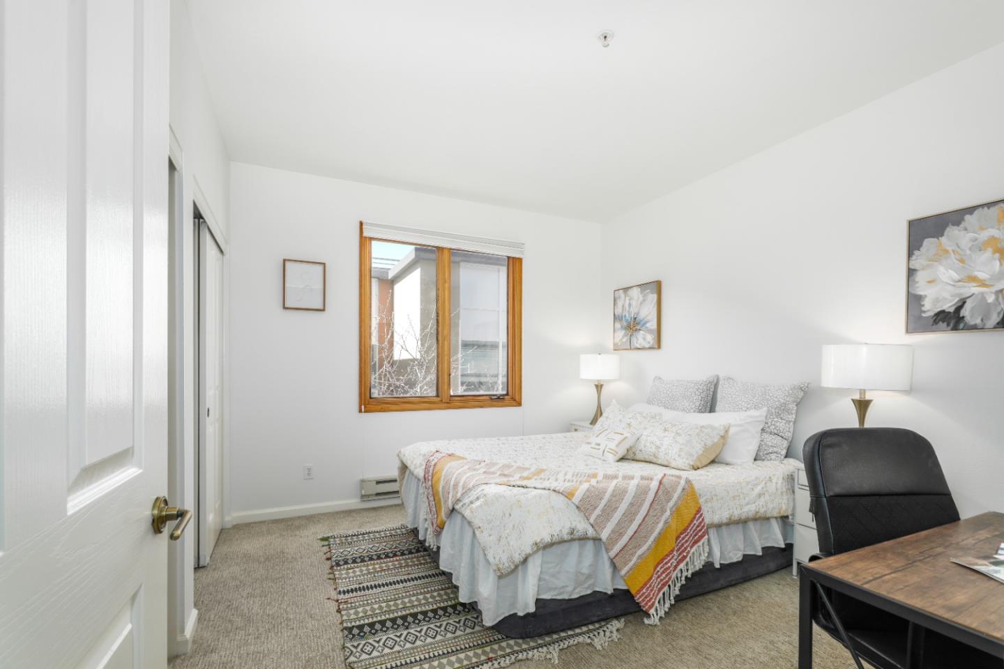 2029 Channing Way, Unit 3C Berkeley, CA 94704 - Photo 15 of 31 a bedroom with a bed lamp and a window