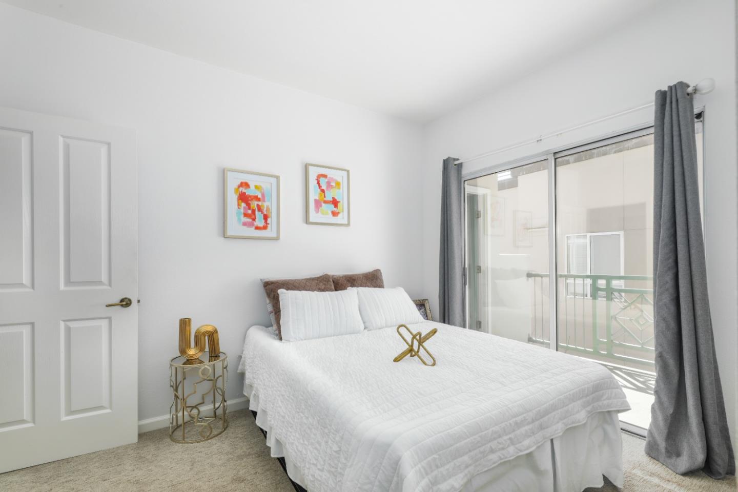 2029 Channing Way, Unit 3C Berkeley, CA 94704 - Photo 17 of 31 a bedroom with a bed and a chandelier