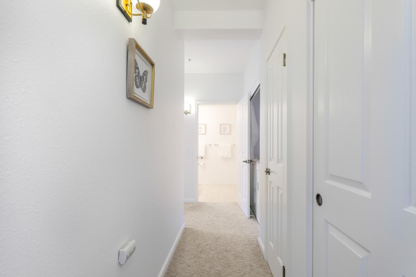 2029 Channing Way, Unit 3C Berkeley, CA 94704 - Photo 19 of 31 a view of a hallway with paintings on the wall