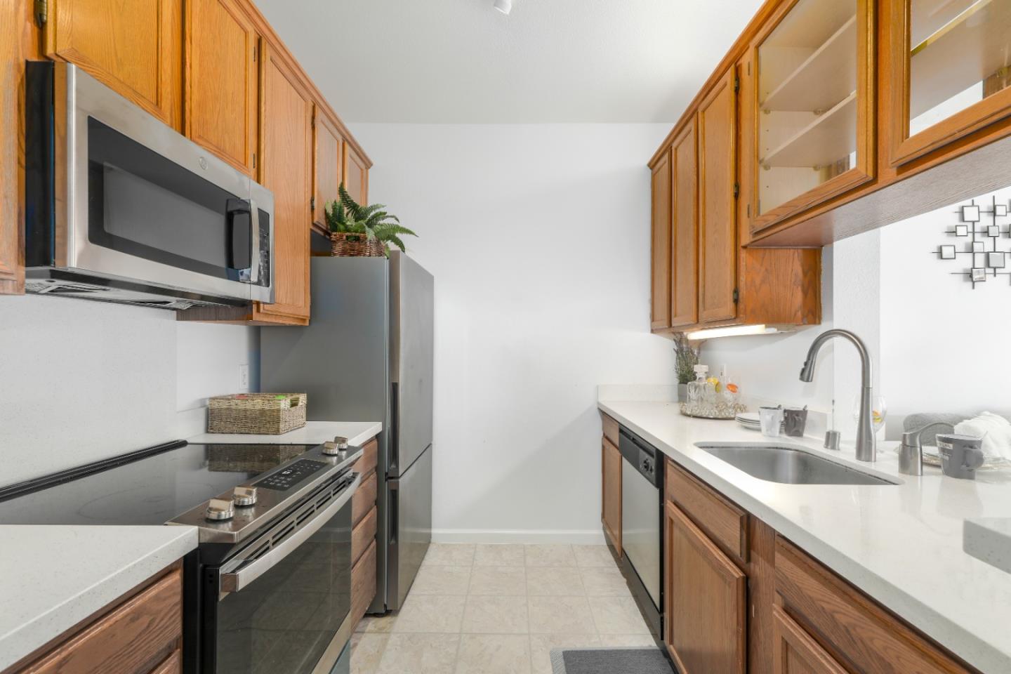 2029 Channing Way, Unit 3C Berkeley, CA 94704 - Photo 10 of 31 a kitchen with stainless steel appliances a stove a sink and a microwave