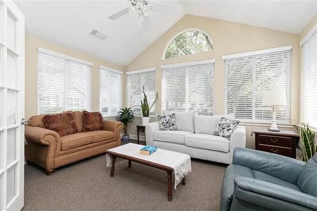 a living room with furniture and a large window
