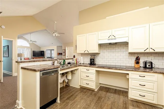 a kitchen with a stove a sink and a refrigerator