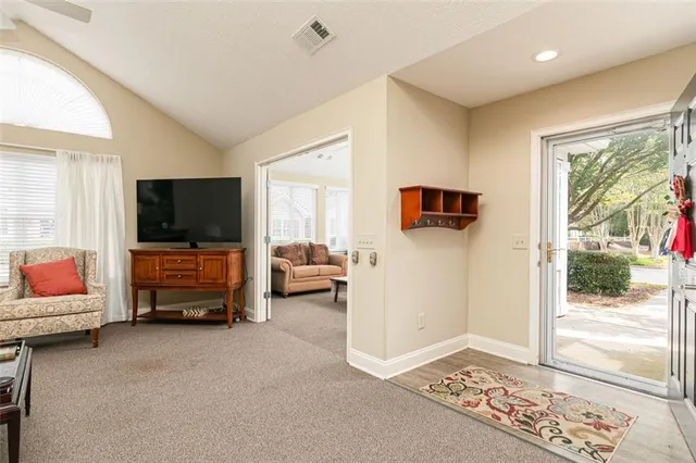a living room with furniture and a flat screen tv