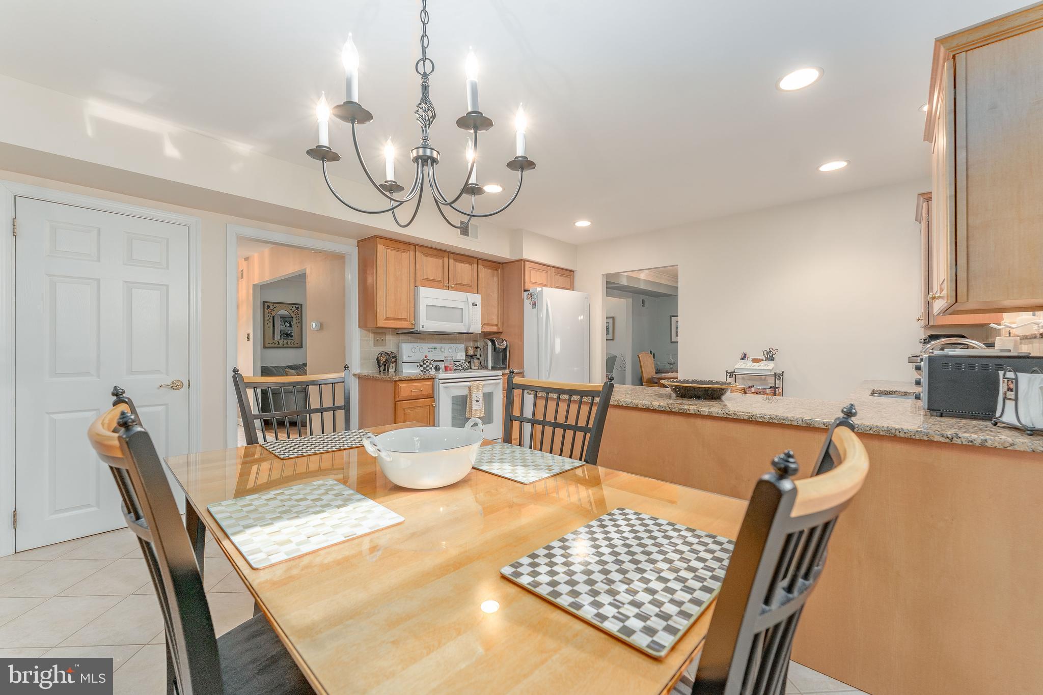 345 Ellis Road Havertown, PA 19083 - Photo 20 of 47 a view of a dining room with furniture a chandelier and wooden floor
