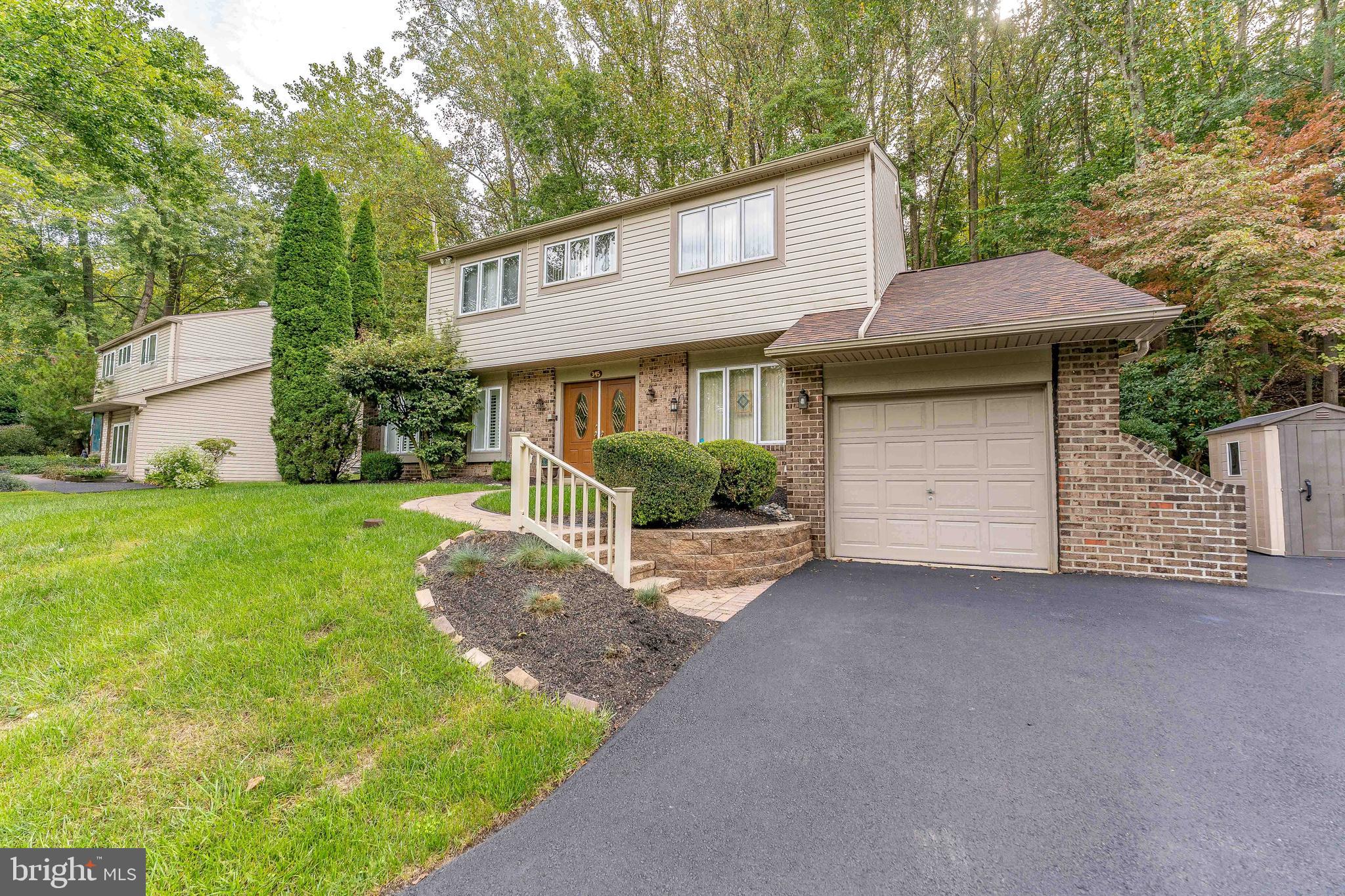 345 Ellis Road Havertown, PA 19083 - Photo 2 of 47 a front view of a house with garden