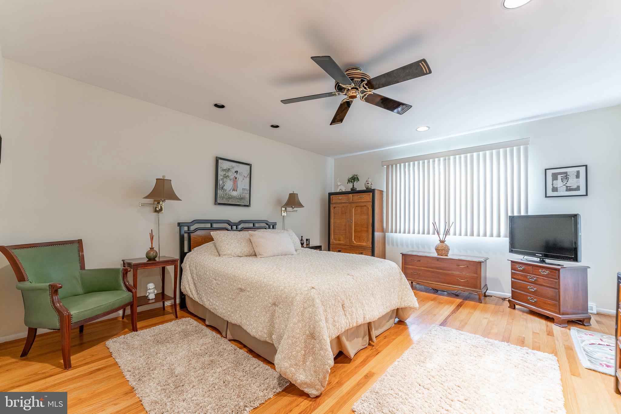 345 Ellis Road Havertown, PA 19083 - Photo 30 of 47 a bedroom with a bed a couch and a flat tv screen on the dresser