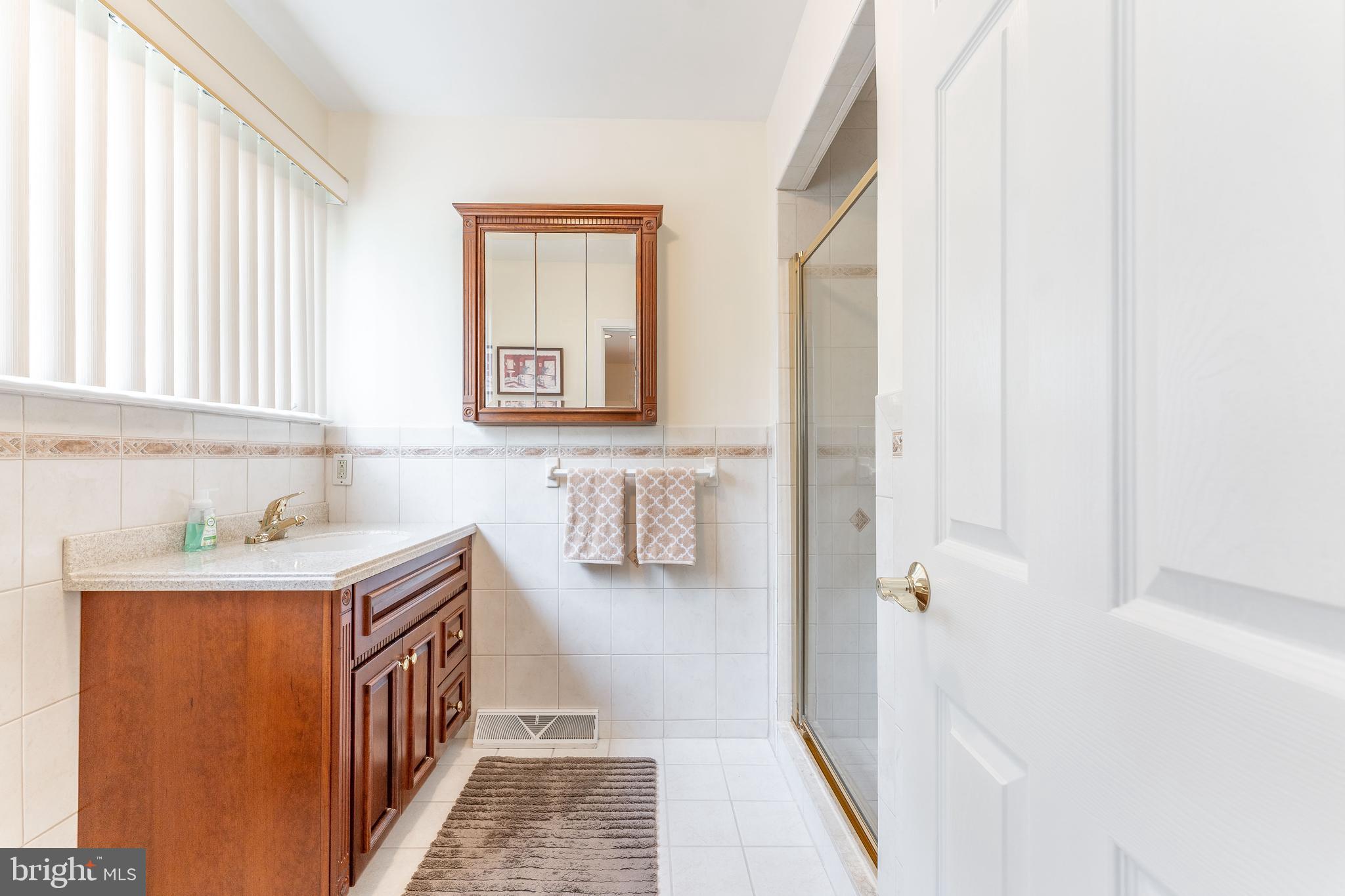 345 Ellis Road Havertown, PA 19083 - Photo 35 of 47 a bathroom with a sink a toilet and a window