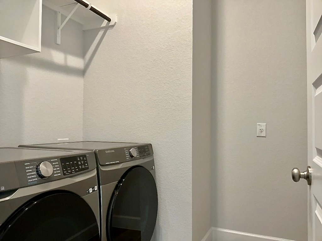 1636 Laverne Mitchell Street Leander, TX 78641 - Photo 18 of 20 Laundry area featuring a textured wall and washer and dryer