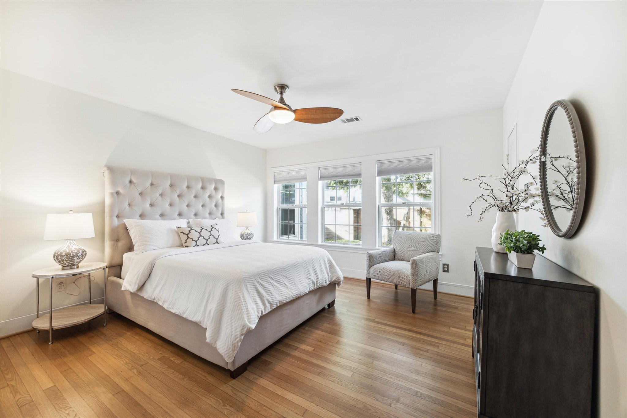 Primary bedroom features hardwood floors and an en-suite bath. The three large windows give ample natural lighting when you want it and custom Levolor Blackout blinds for those times you want to sleep in!