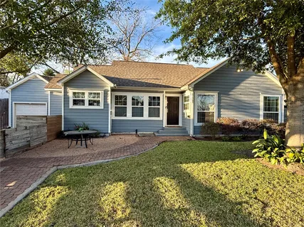 a backyard of a house with table and chairs