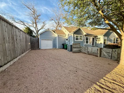 a view of a house with backyard porch and sitting area