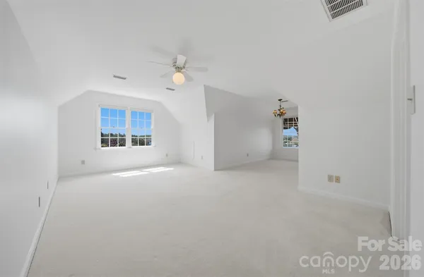 an empty room with a empty space and windows