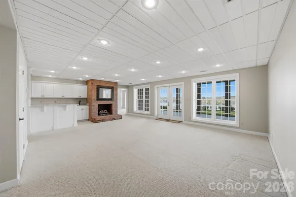 a view of an empty room with a kitchen