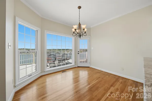 a view of a room with wooden floor