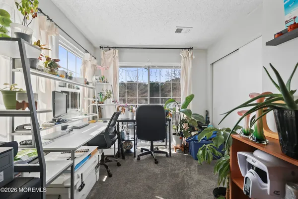a view of a workspace with furniture and a potted plant