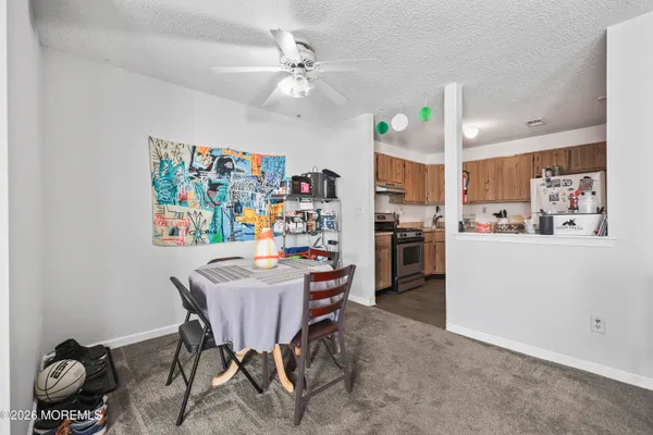 a dining room with furniture and a kitchen view