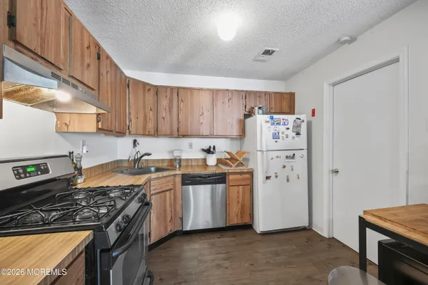 a kitchen with a stove a refrigerator and a stove