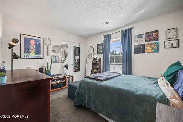 a bedroom with a bed and a desk