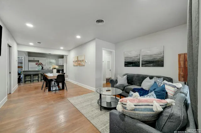 a living room with furniture and kitchen view