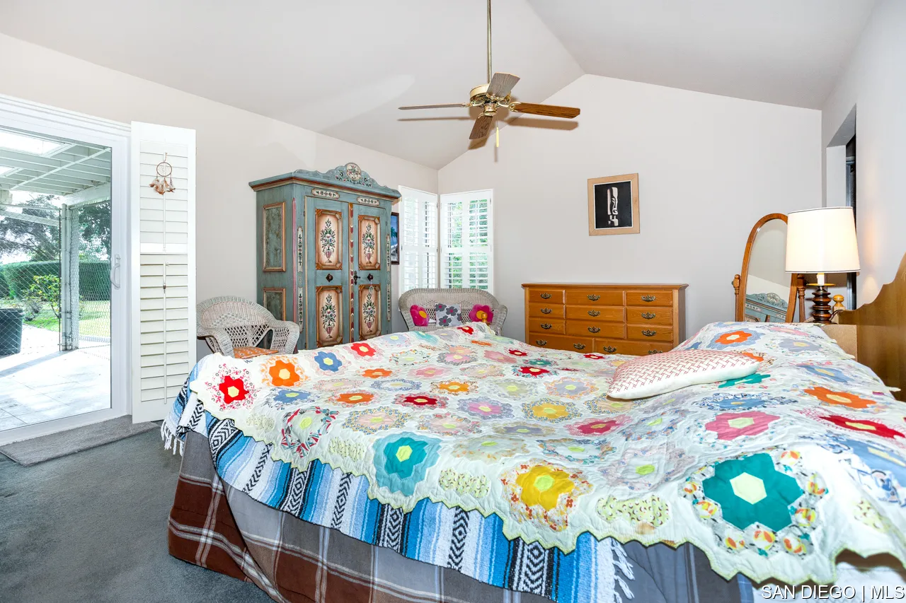 619 Elm Tree Lane Fallbrook, CA 92028 - Photo 28 of 28 a bedroom that has a bed and a table in it