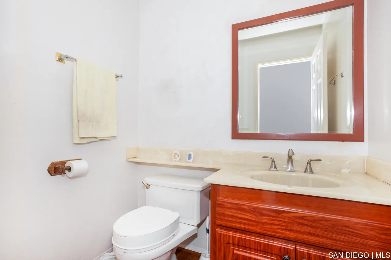 619 Elm Tree Lane Fallbrook, CA 92028 - Photo 5 of 28 a bathroom with a sink vanity mirror and toilet