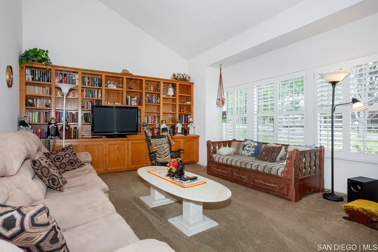 619 Elm Tree Lane Fallbrook, CA 92028 - Photo 9 of 28 a living room with furniture a flat screen tv and a floor to ceiling window