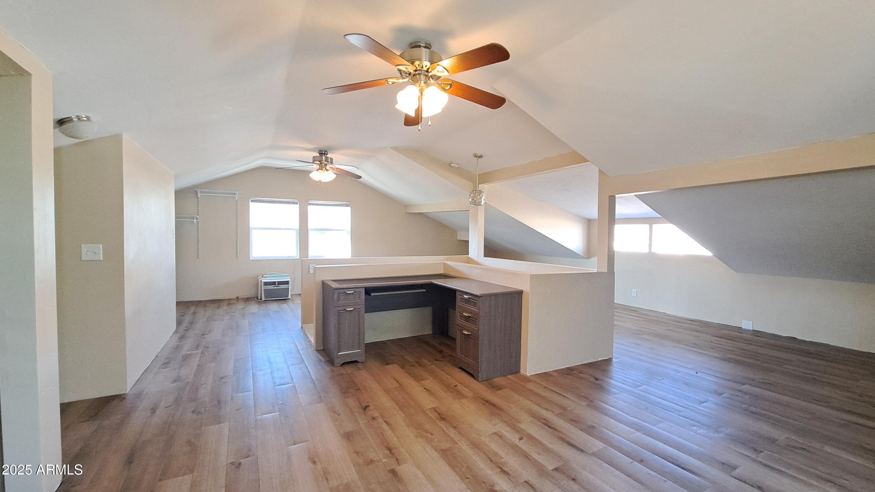 507 Bisbee Road Bisbee, AZ 85603 - Photo 13 of 26 a view of an empty room with a window and wooden floor