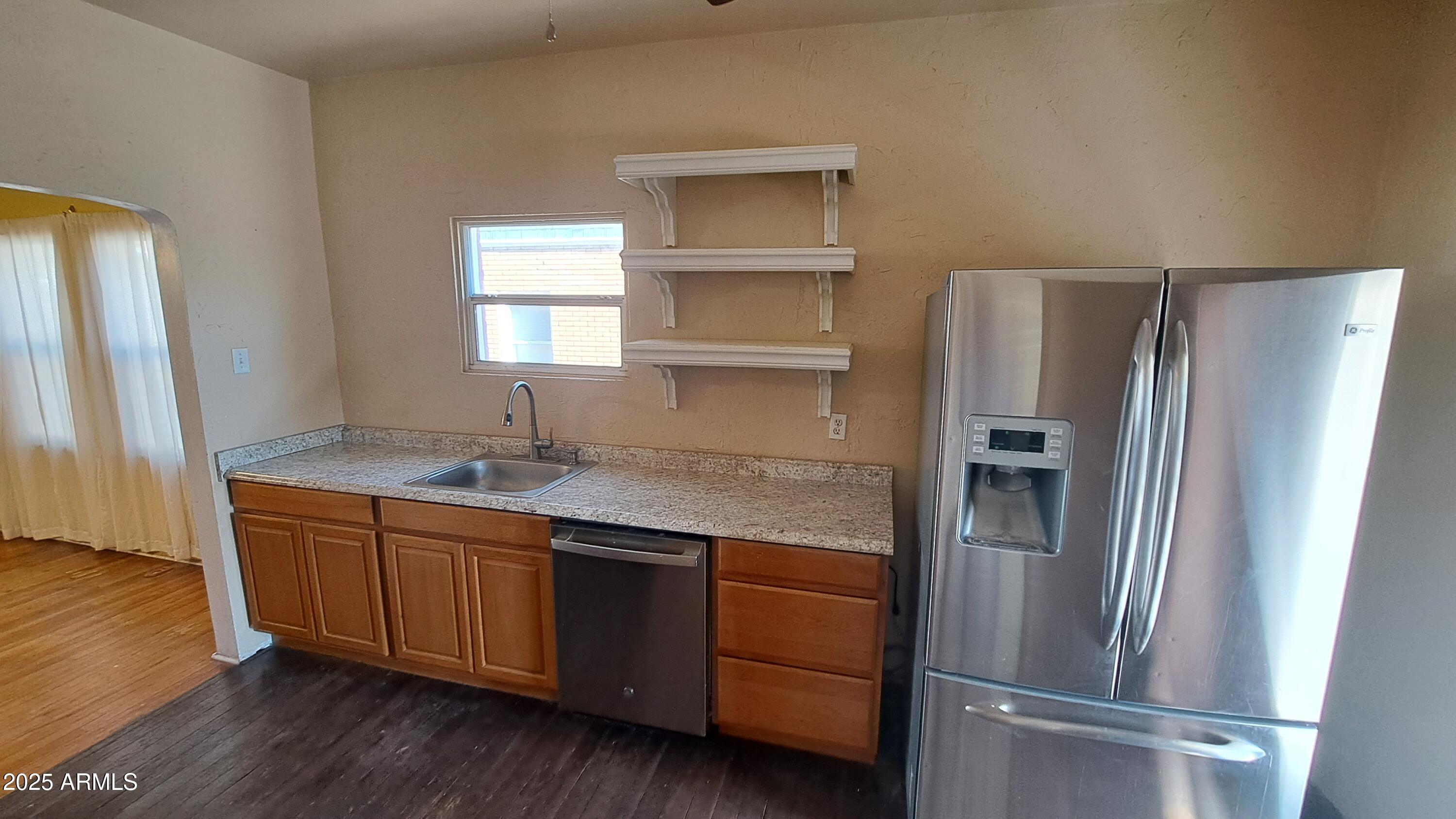 507 Bisbee Road Bisbee, AZ 85603 - Photo 18 of 26 a kitchen with stainless steel appliances granite countertop a refrigerator and a sink