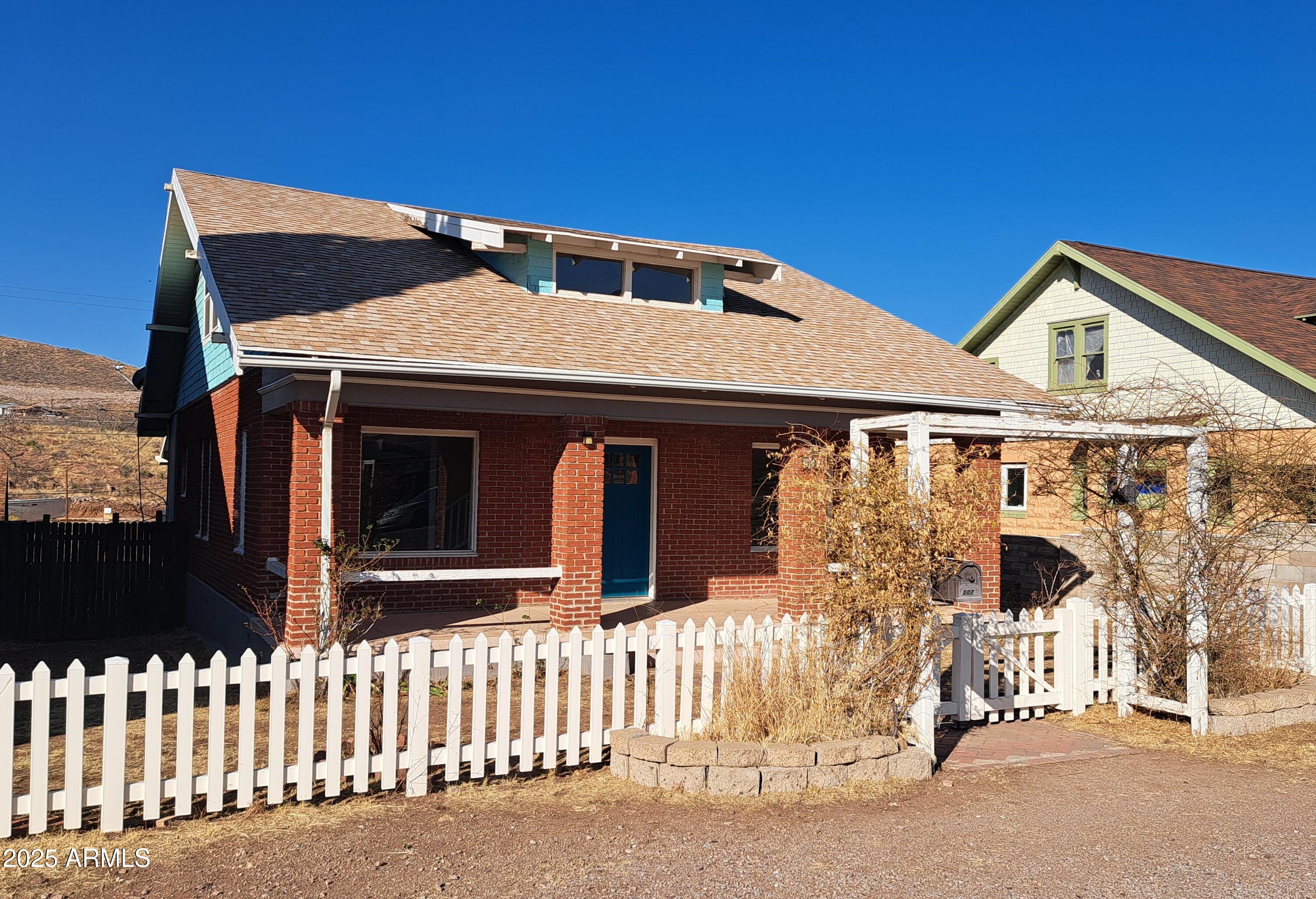 507 Bisbee Road Bisbee, AZ 85603 - Photo 2 of 26 a front view of a house with a garage