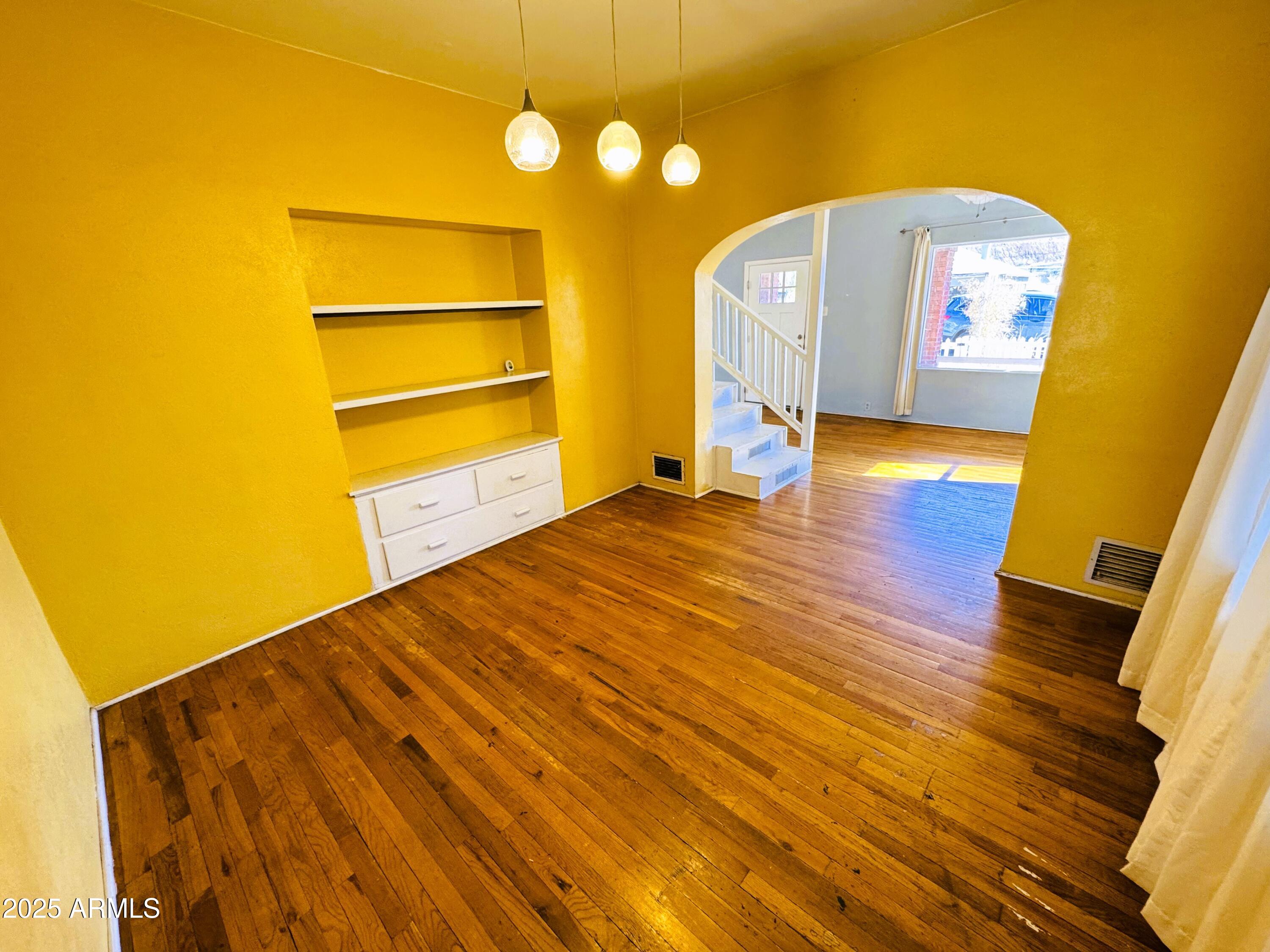 507 Bisbee Road Bisbee, AZ 85603 - Photo 4 of 26 a view of an empty room with wooden floor