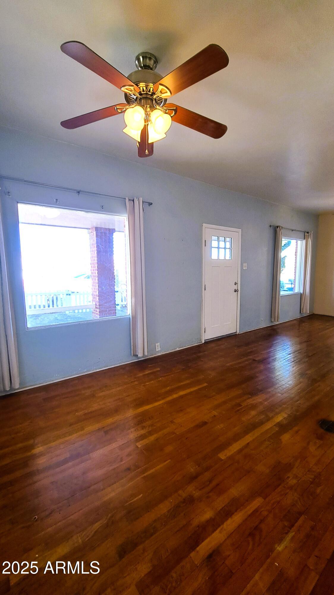 507 Bisbee Road Bisbee, AZ 85603 - Photo 8 of 26 wooden floor in an empty room with a window