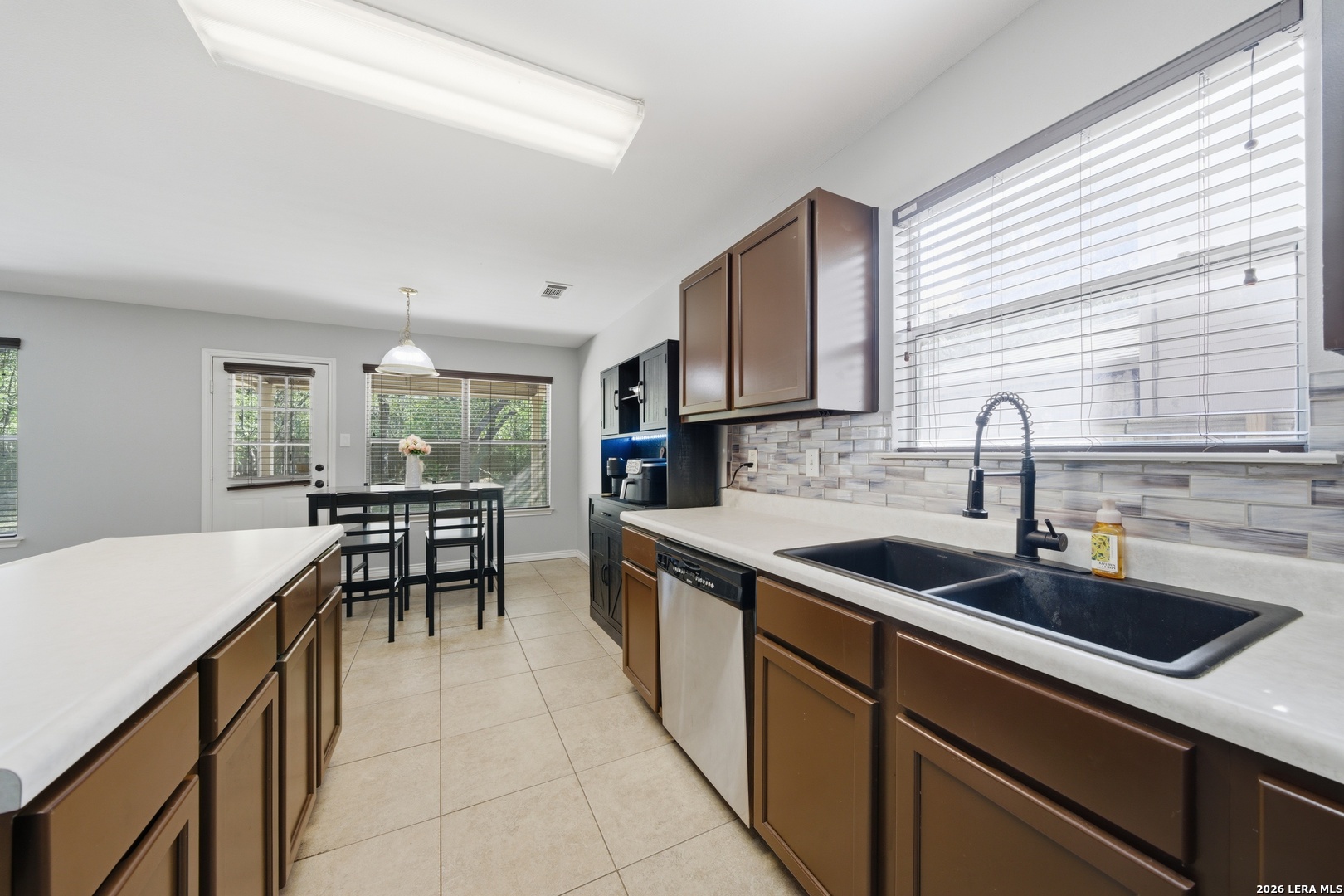 11622 Shotgun Way Helotes, TX 78023 - Photo 13 of 35 a kitchen with a sink and cabinets