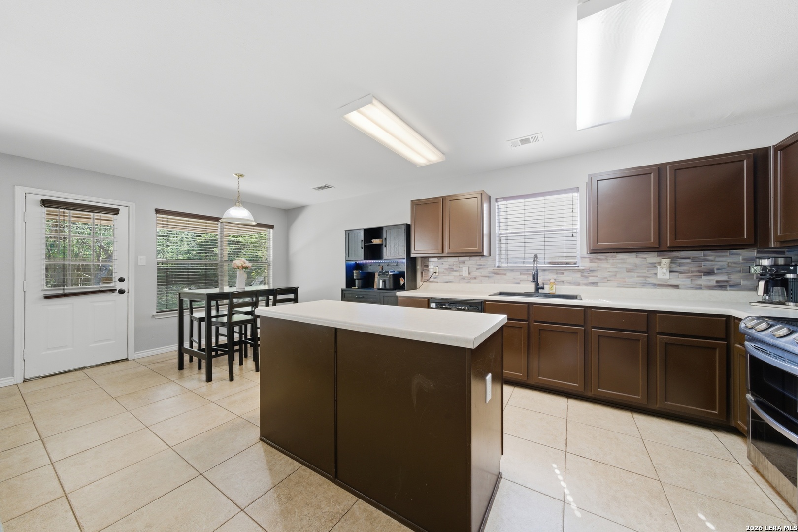 11622 Shotgun Way Helotes, TX 78023 - Photo 14 of 35 a kitchen with cabinets and chairs