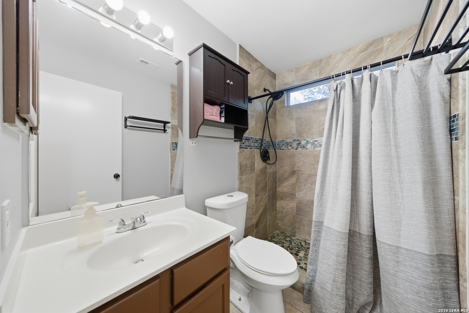 11622 Shotgun Way Helotes, TX 78023 - Photo 18 of 35 a bathroom with a sink toilet and shower