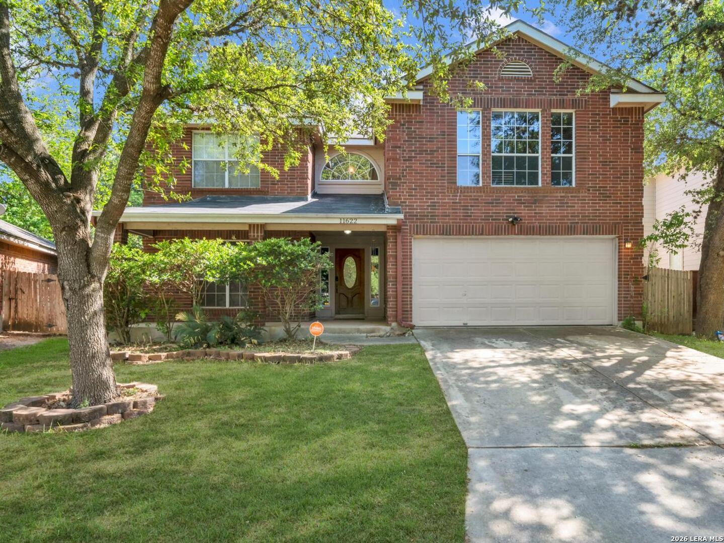 11622 Shotgun Way Helotes, TX 78023 - Photo 2 of 35 a front view of a house with a yard and trees