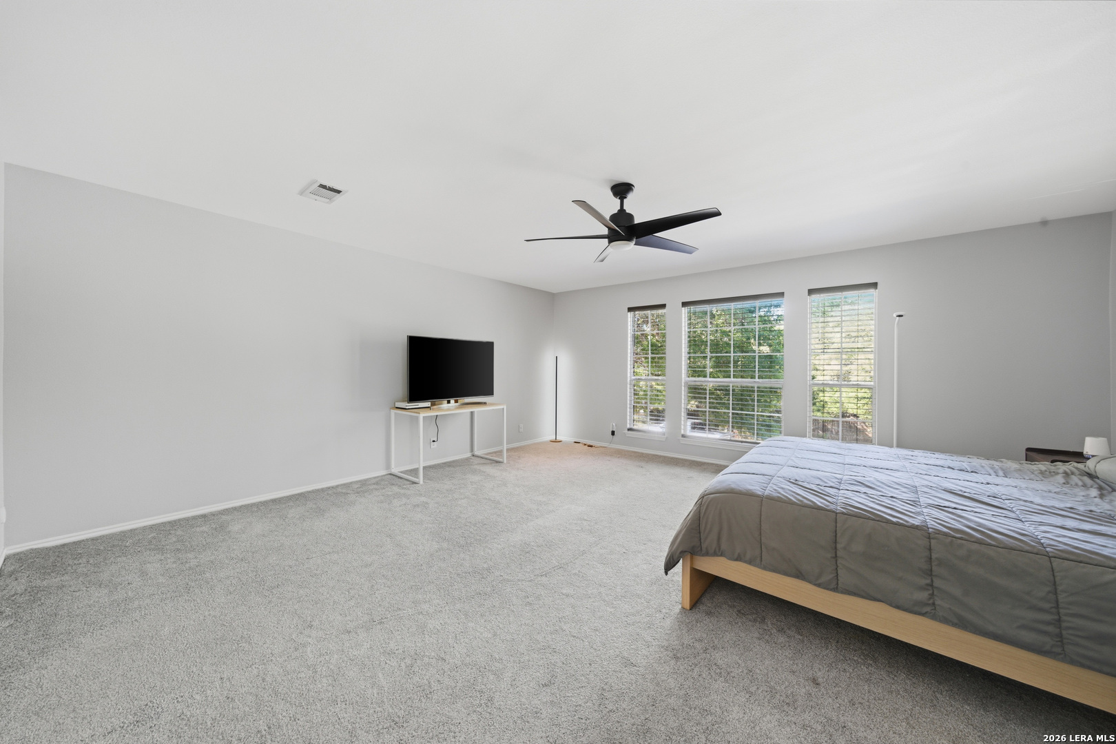 11622 Shotgun Way Helotes, TX 78023 - Photo 24 of 35 a bed sitting in a spacious bedroom next to a window