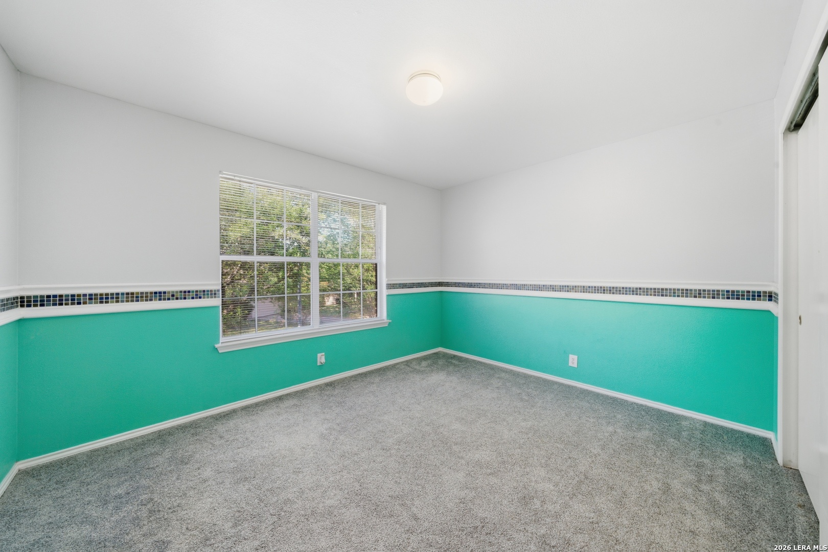 11622 Shotgun Way Helotes, TX 78023 - Photo 28 of 35 an empty room with a window and a ceiling fan