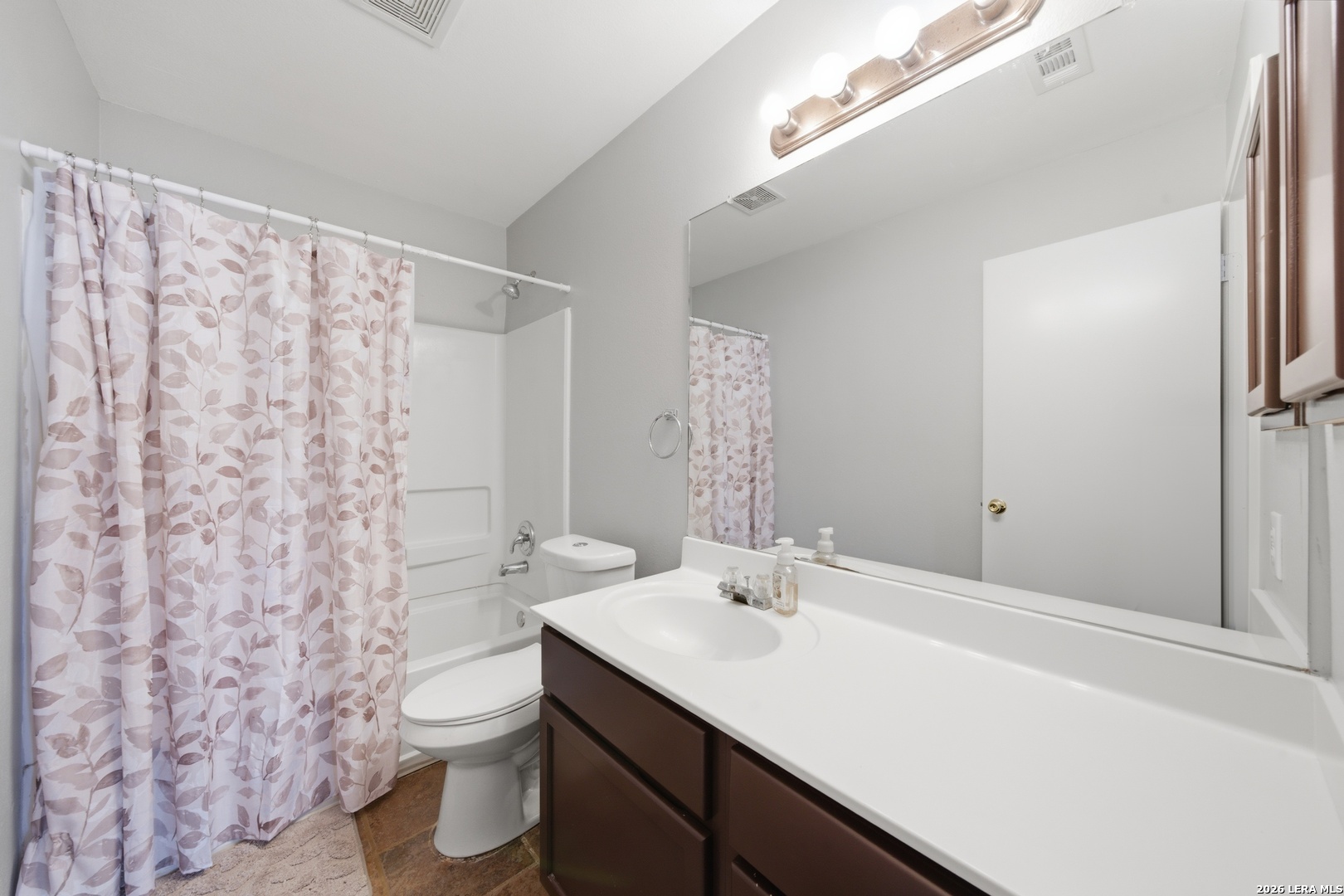 11622 Shotgun Way Helotes, TX 78023 - Photo 30 of 35 a bathroom with a sink toilet and shower