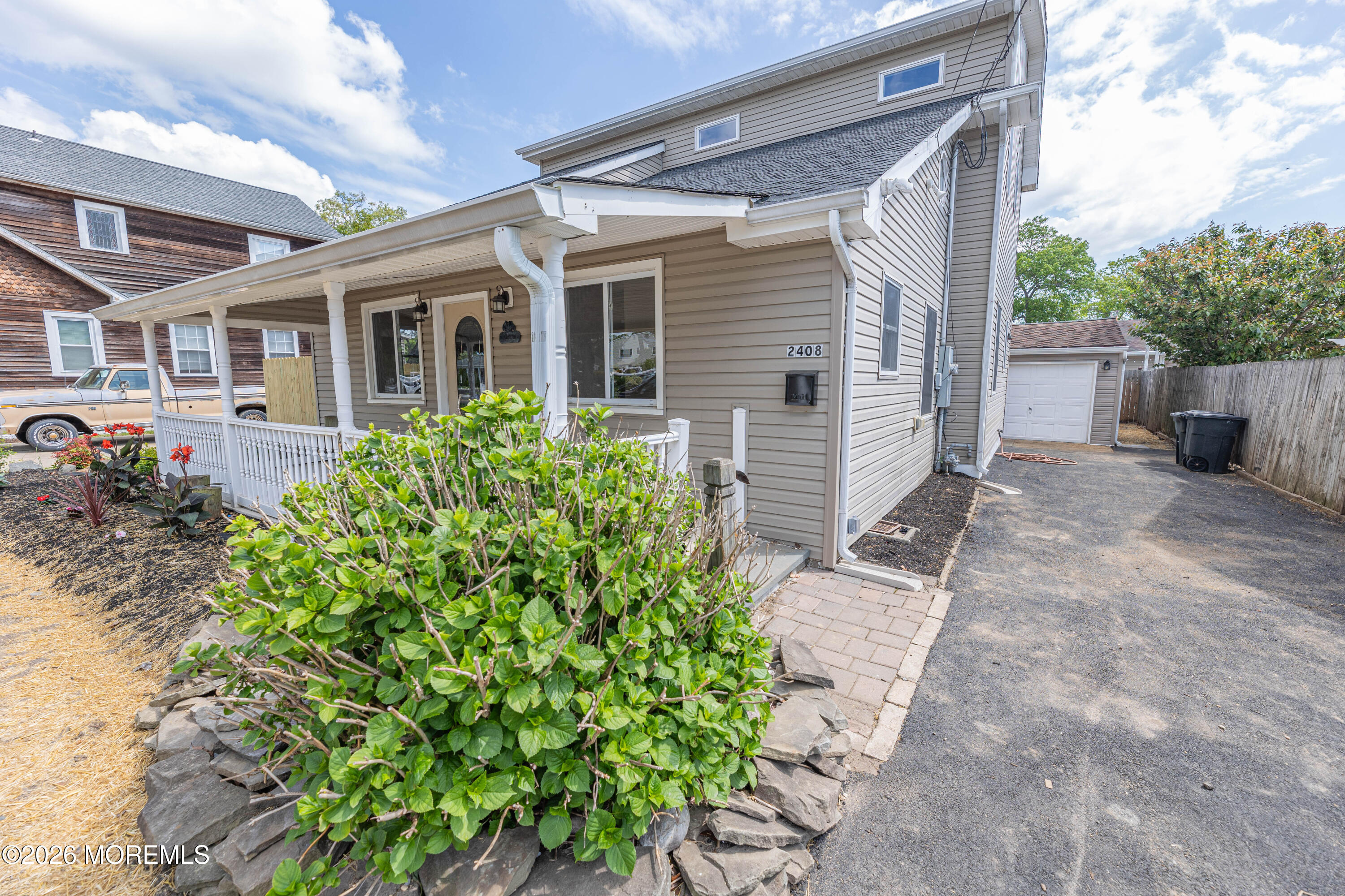 2408 Herbertsville Road Point Pleasant, NJ 08742 - Photo 70 of 82 a view of a house with a small yard and plants