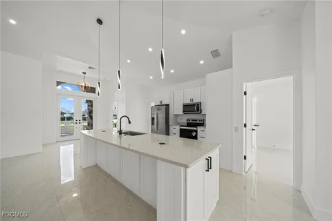 a kitchen with stainless steel appliances a refrigerator stove and microwave