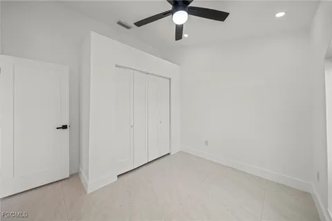 a bathroom with a granite countertop sink a mirror and shower
