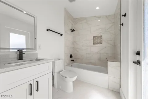 a bedroom with a bed and glass window