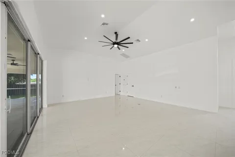 a living room with furniture a ceiling fan and a rug