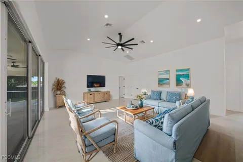 en empty room with windows and ceiling fan