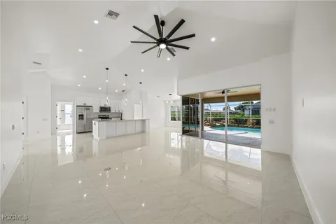 a view of a kitchen with a sink and a refrigerator
