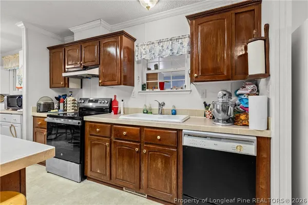 a kitchen with stainless steel appliances kitchen island granite countertop a refrigerator a stove a sink dishwasher a dining table and chairs with wooden floor