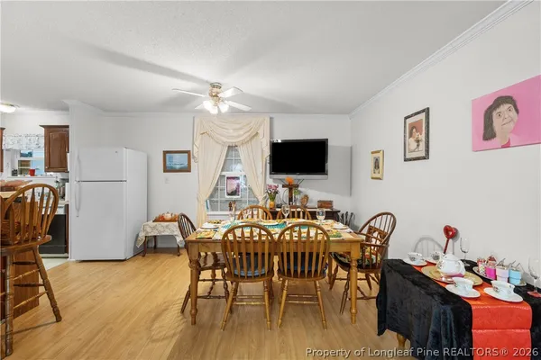 a view of a dining room with furniture and wooden floor
