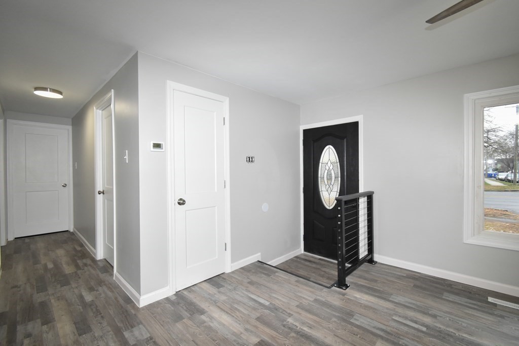 1094 Sumner Avenue Springfield, MA 01118 - Photo 11 of 35 an empty room with wooden floor mirror and window