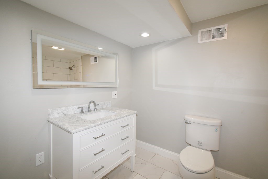 1094 Sumner Avenue Springfield, MA 01118 - Photo 19 of 35 a bathroom with a toilet sink and mirror